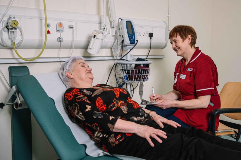 Nurse and patient interacting in clinical setting